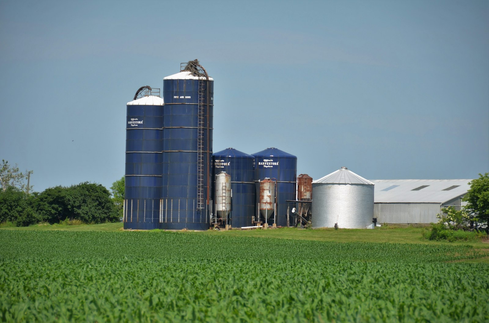 A vintage blue grain storage silo on a rural farm