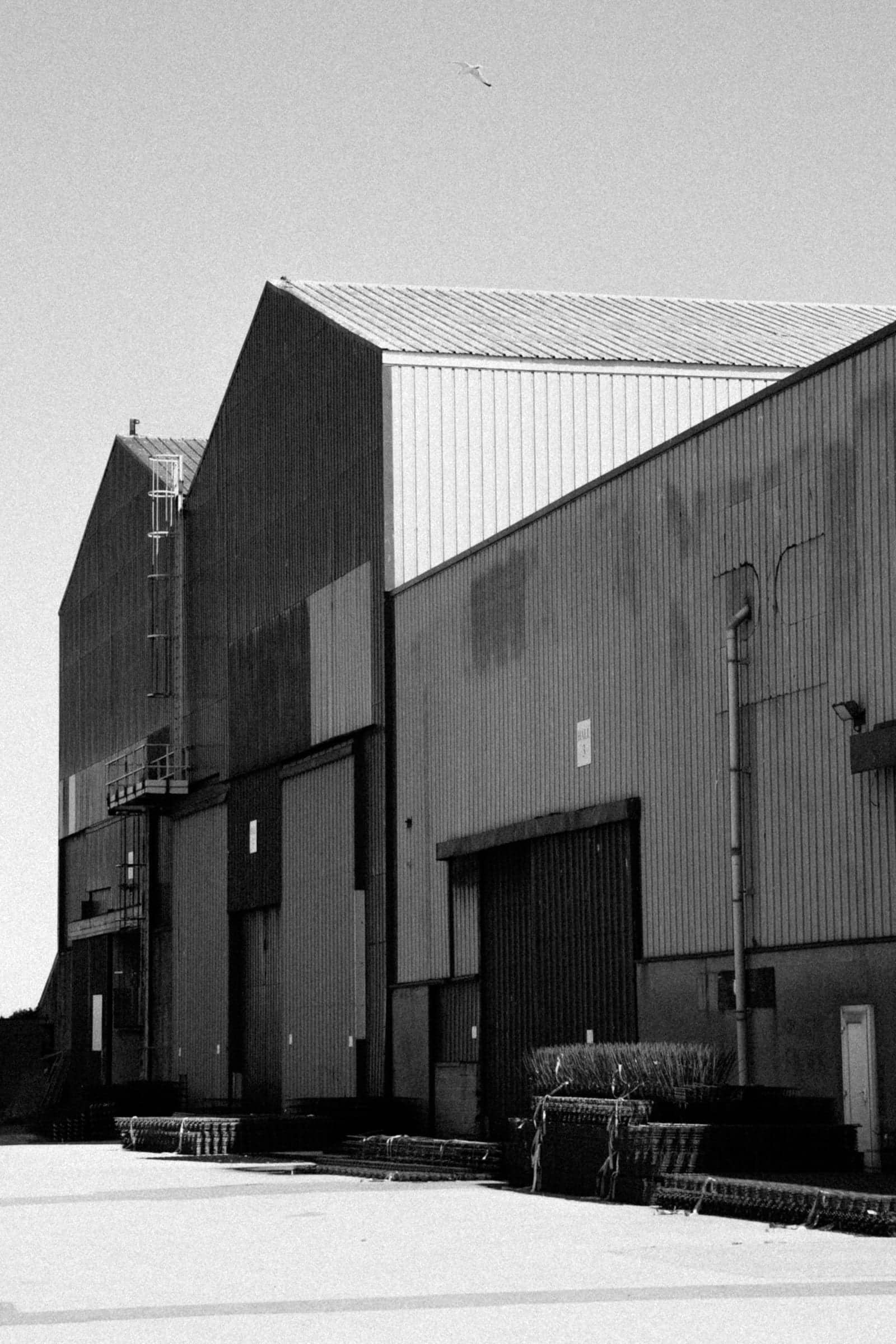 Industrial metal buildings with corrugated steel siding under a clear sky