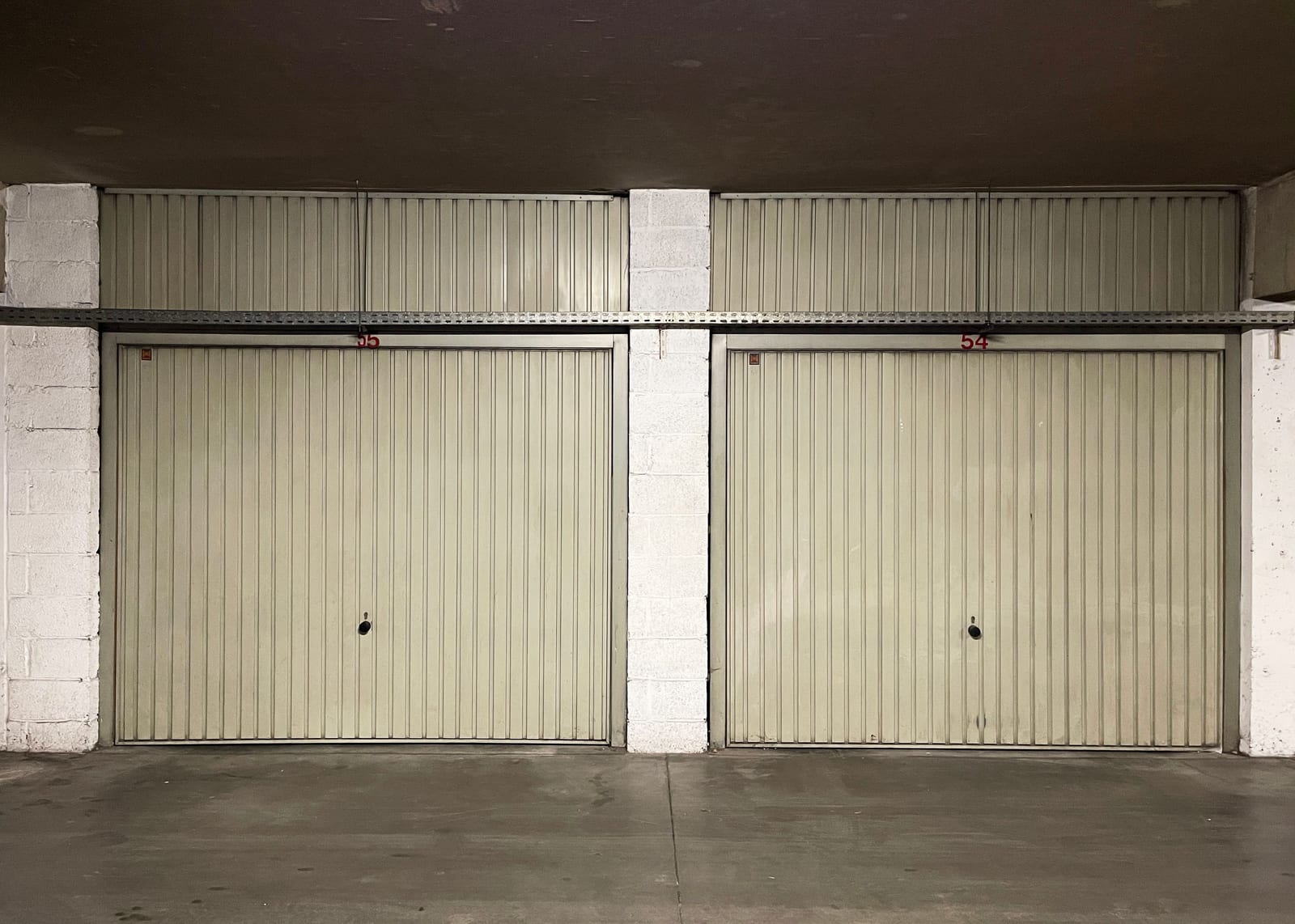 Two closed garage doors inside an industrial metal building